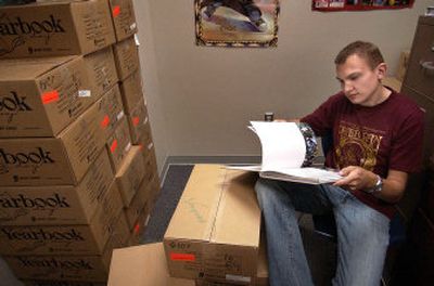 
Central Valley High senior Chris Engle looks through a yearbook for any defects in his office at CV. Engle is the yearbook editor.
 (Liz Kishimoto / The Spokesman-Review)