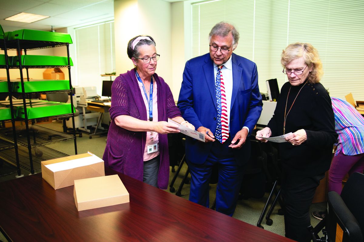 Bill Burgess, Marion County Clerk, center, works with elections clerk Jo Anne Lepley, left, and Jan Coleman to locate ballot return envelopes on Sept. 28 at the Marion County Clerk’s Office.  (Amanda Loman)