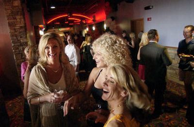 
From left, Connie Wendlandt, Victoria Guindon and Sue Spinazza enjoy a party at the opening of Regal Cinemas' Riverstone Stadium 14-screen theater in Coeur d'Alene on Wednesday. 
 (Tom Davenport/ / The Spokesman-Review)