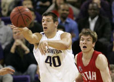
Washington's Jon Brockman gets off a pass in front of Utah's Luka Drca during the first half Wednesday. Associated Press
 (Associated Press / The Spokesman-Review)