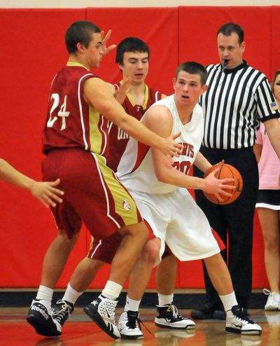 Ferris' Riley Stockton, right, gets trapped by University High's Conner Johnson, left, and CJ Cornell, behind, on Friday, Jan. 28, 2011, at Ferris. (Jesse Tinsley / The Spokesman-Review)