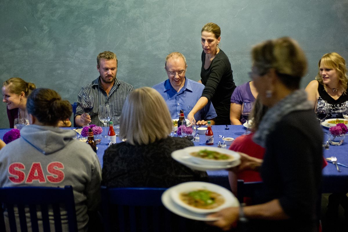 Karen Johnson, foreground and Julia Postlewait, center standing, serve food to guests at Blue Table Kitchen in Millwood. (TYLER TJOMSLAND photos)