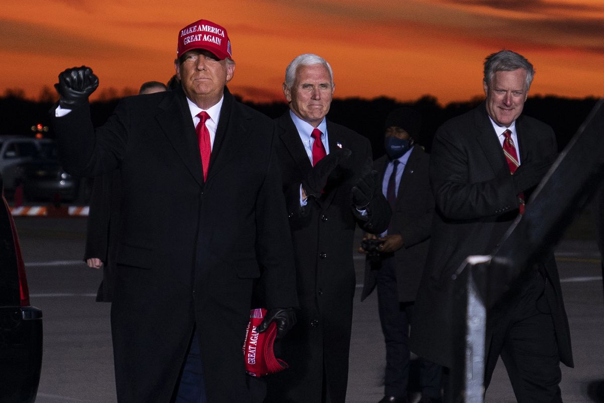 President Donald Trump and Vice President Mike Pence arrive for a campaign rally at Cherry Capital Airport, Monday, Nov. 2, 2020, in Traverse City, Mich., with White House chief of staff Mark Meadows, right. Meadows has been diagnosed with the coronavirus as the nation sets daily records for confirmed cases for the pandemic.  (Evan Vucci)