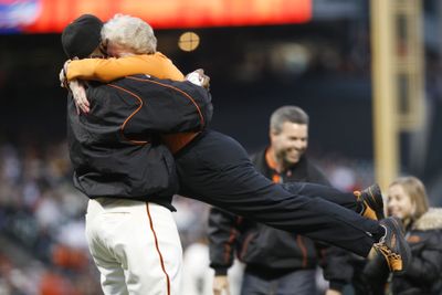 Barry Bonds lifts Giants part-owner Sue Burns off her feet before a 2007 game. Burns died Sunday at age 58. (Associated Press / The Spokesman-Review)