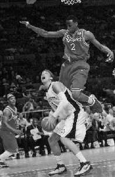 
SJU's Anthony Mason Jr. jumps over Marquette's Dan Fitzgerald. 
 (Associated Press / The Spokesman-Review)