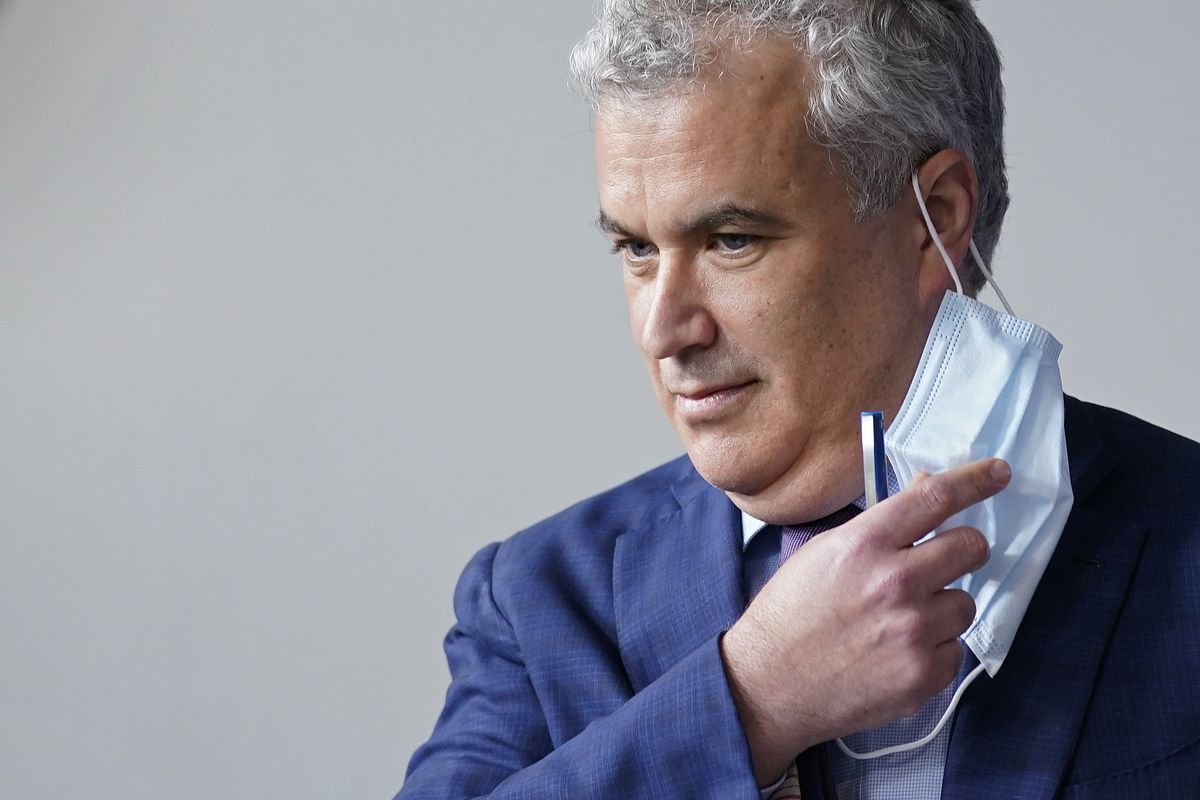 FILE - White House COVID-19 Response Coordinator Jeff Zients removes a face mask as he prepares to speak at a press briefing at the White House in Washington, April 13, 2021. The White House said Wednesday, Feb. 9, 2022, that it was beginning to prepare for the next phase of the pandemic response amid growing impatience for the federal government to ease up. Zients said officials have started consultations in recent weeks with state and local leaders and public health officials “on steps we should be taking to keep the country moving forward.” (Patrick Semansky)