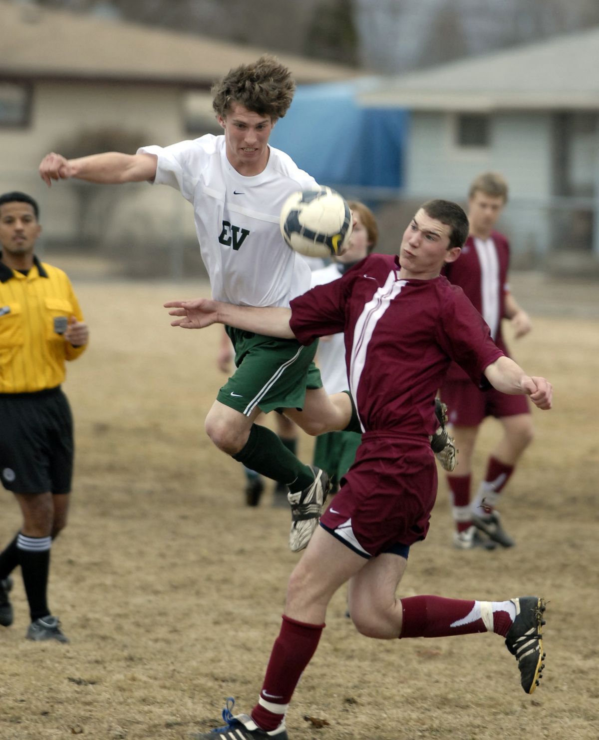 East Valley forward John Gjendem dances through air while concentrating on the ball against University defender Zach Polsin during the first half of their soccer game March 18. U-Hi beat the Knights 1-0.  (Photos by J. BART RAYNIAK / The Spokesman-Review)