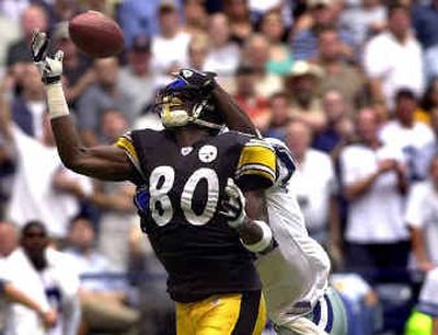 
Steelers receiver Plaxico Burress attempts to make a first-quarter catch with Dallas' Terence Newman draped all over him. 
 (Associated Press / The Spokesman-Review)