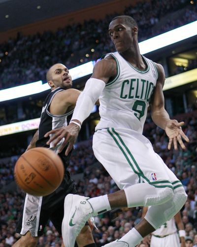 Boston’s Rajon Rondo, who finished with 22 assists, 12 points and 10 rebounds, passes in front of San Antonio’s Tony Parker.  (Associated Press)