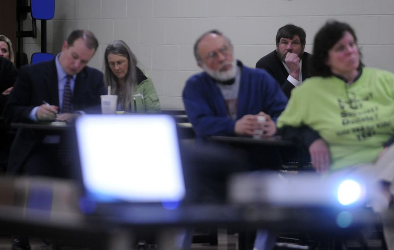 East Valley School District Superintendent John Glenewinkel, second from right, listens as EV Executive Director of Operations Brian Wallace presents the fiscal future of the school district and upcoming bond at an informational meeting March 15. (J. Bart Rayniak)