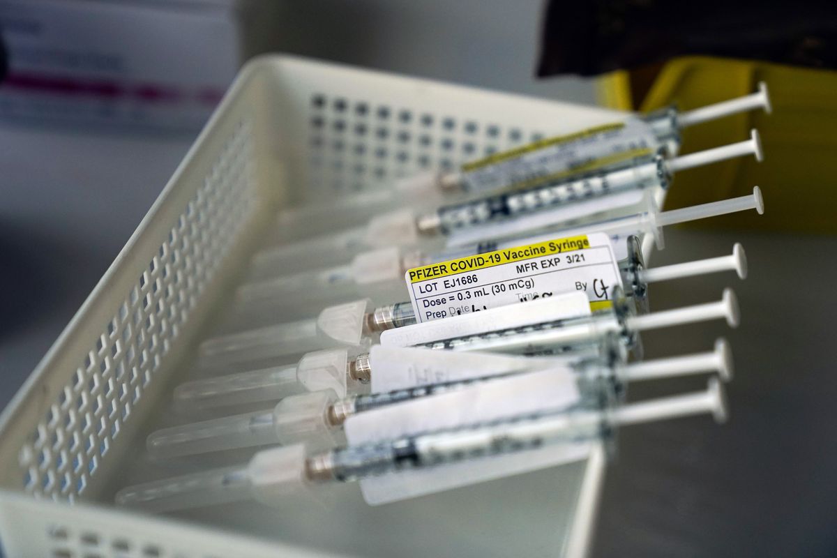 Syringes containing the Pfizer-BioNTech COVID-19 vaccine sit in a tray in a vaccination room at St. Joseph Hospital in Orange, Calif., Thursday.  (Jae C. Hong)