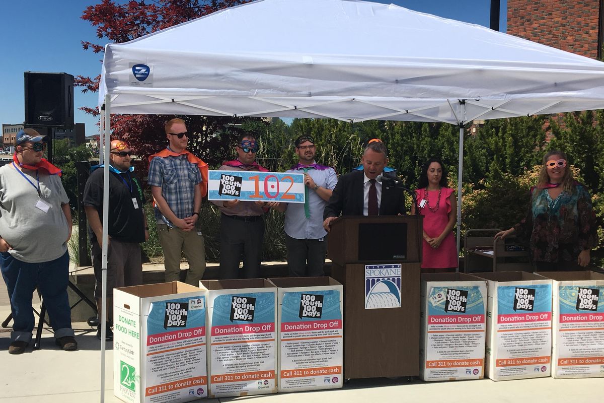 Mayor David Condon announces the City of Spokane and nonprofit partners found housing for 102 young homeless people during a housing campaign on Monday, July 31, 2017. Condon, flanked by team members who were awarded capes and masks for their “superhero” effort, said the work showed the success of networking services for a homeless population that is sometimes difficult to reach. (Kip Hill / The Spokesman-Review)