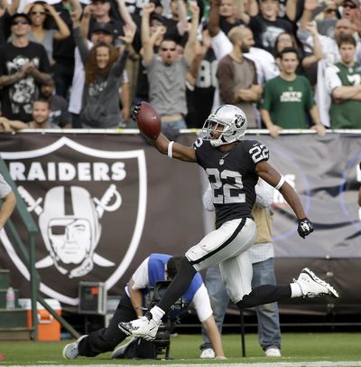 Taiwan Jones scores for the Raiders on Nov. 1, turning a short sideline pass into a 59-yard score. (Marcio Sanchez / Associated Press)