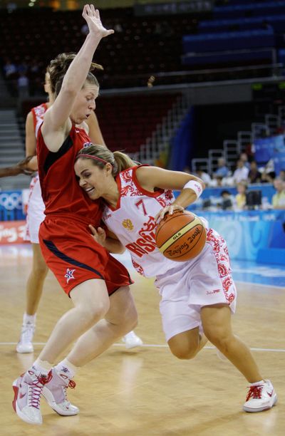 Associated Press Russia’s Becky Hammon drives past Katie Smith of the United States during Thursday’s semifinal. (Associated Press / The Spokesman-Review)