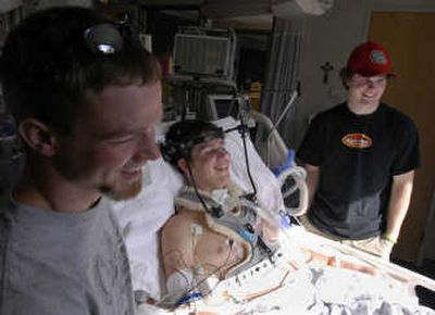 
From left, Brian Walker, Casey McKern and Cody Nailor watch videos on Sunday in the intensive care unit of Sacred Heart Medical Center. The three are 2006 graduates of Kettle Falls High School. 
 (J. BART RAYNIAK / The Spokesman-Review)