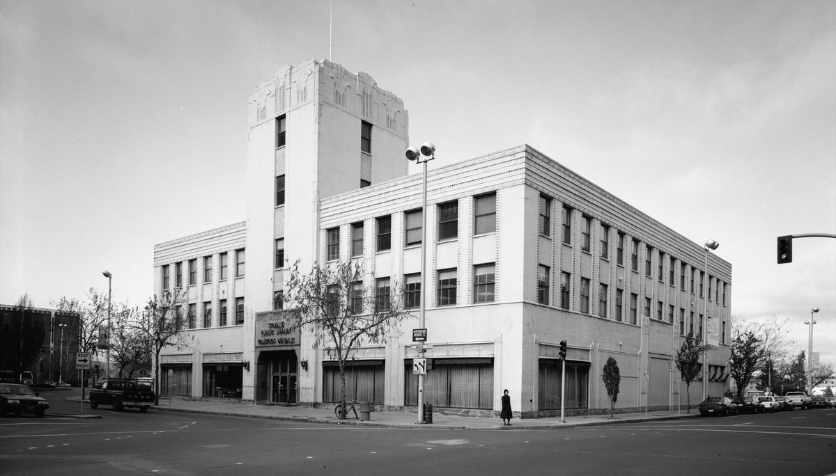 Circa 1990: The 1930 Sears, Roebuck & Co. building at Main Avenue and Lincoln Street was repurposed into the Spokane Public Library in the early 1960s. The structure served the department store for 30 years, then as the downtown library for 30 years before being torn down in 1992. It was an example of art deco architecture, though library historian Nancy Compau wasn’t sorry to see it go. “I’m not terribly enamored with it,” she said in 1990, “and I work in the building. We have other fine examples of art deco architecture – City Ramp Garage, new City Hall (the old Montgomery Ward building) and the Fox Theater.”  (Library of Congress)