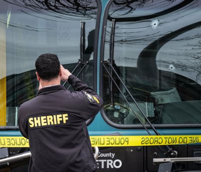 Several bullet holes can be seen in the driver's side window of a Metro Bus on Northeast 125th Street, between 32nd and 33rd Avenues Northeast after a shooting in Seattle, Wednesday March 27, 2019. (Dean Rutz / associated press)