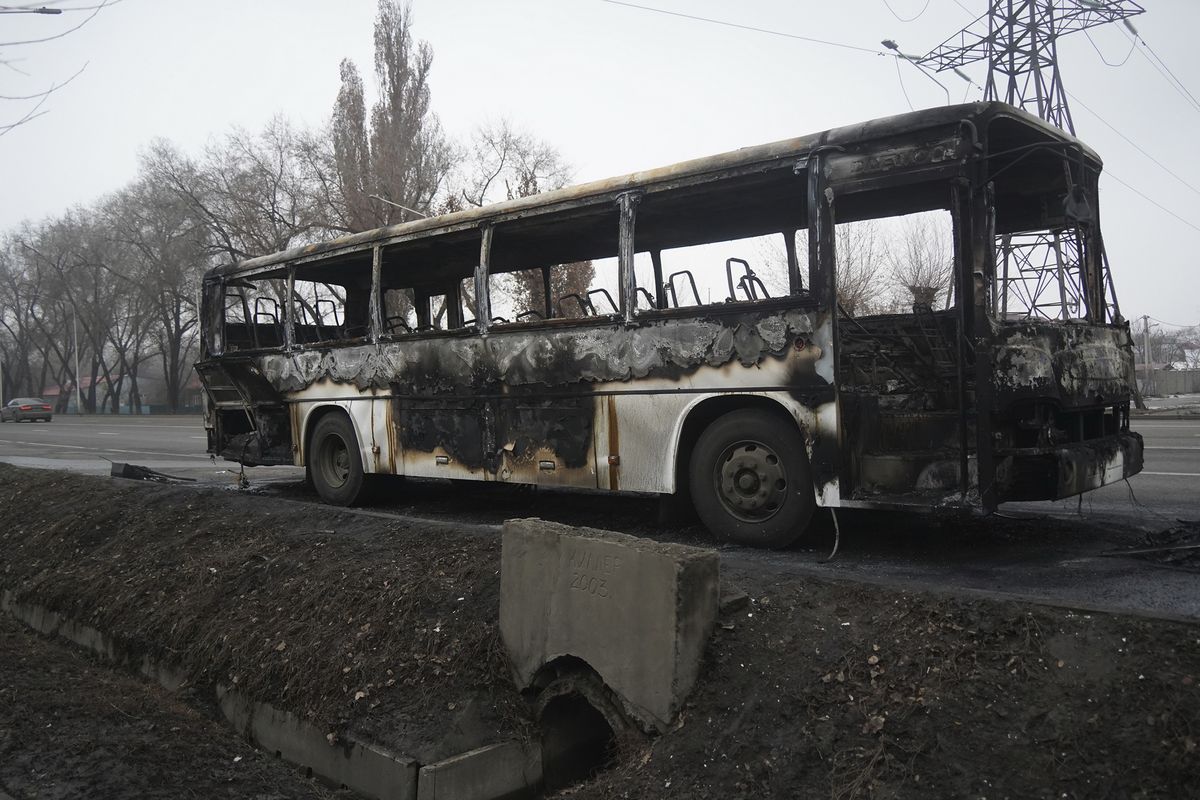A bus, which was burned during clashes, is seen on a street in Almaty, Kazakhstan, Sunday, Jan. 9, 2022. Kazakhstan