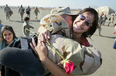 
A fmily is reunited in Fresno, calif., after a husband's tour of duty in Iraq. Some employers are stepping in to help spouses find work.
 (Associated Press / The Spokesman-Review)