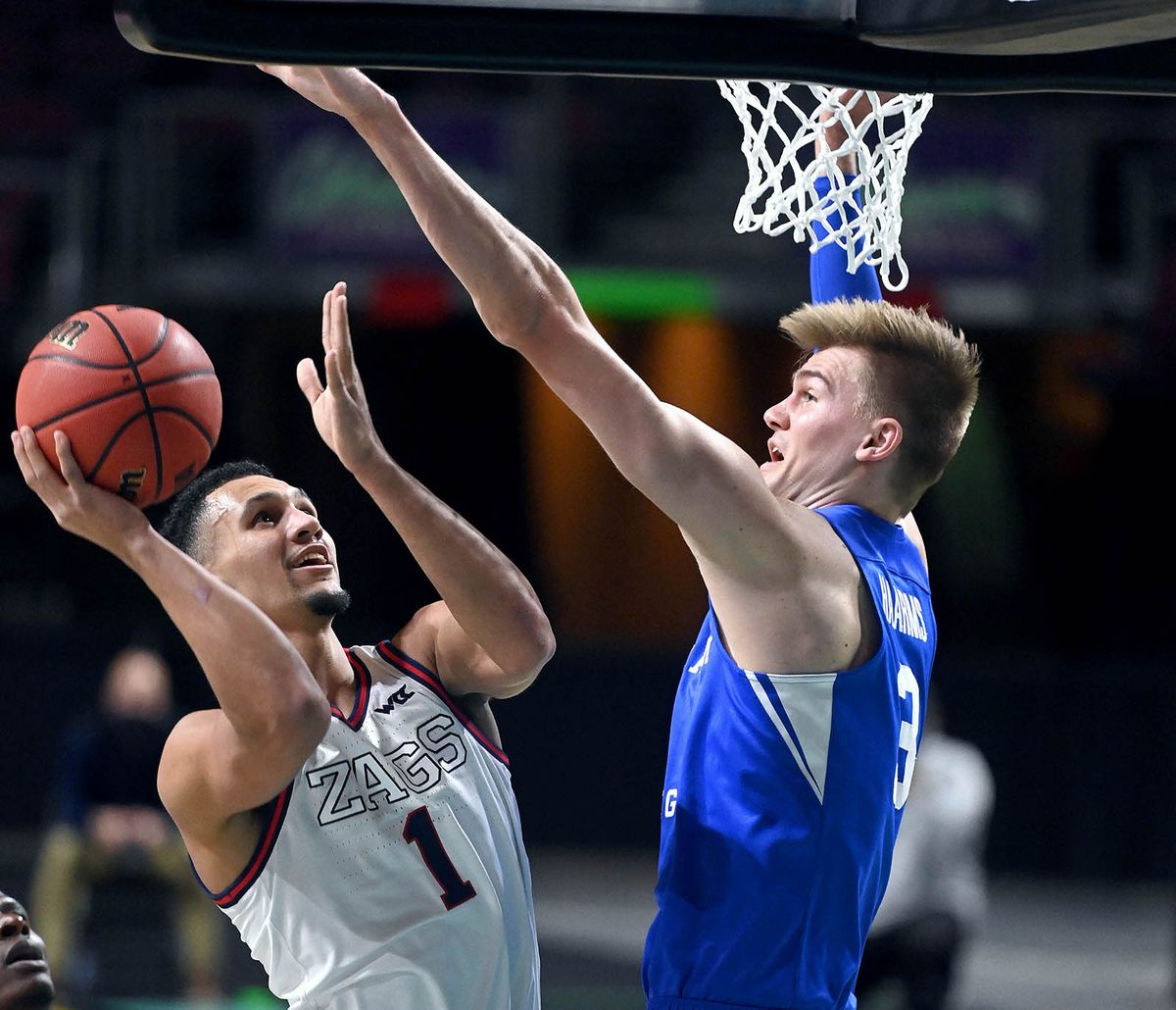 Gonzaga guard Jalen Suggs (1) takes a shot as BYU forward Matt Haarms (3) defends during the first half of a West Coast Conference Tournament final NCAA college basketball game, Tuesday, March 9, 2021, at the Orleans Arena in Las Vegas.  (COLIN MULVANY/THE SPOKESMAN-REVIEW)