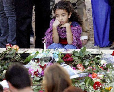 
A child sits by a reflecting pool during Sunday's ceremony at the World Trade Center in New York. 
 (Associated Press / The Spokesman-Review)