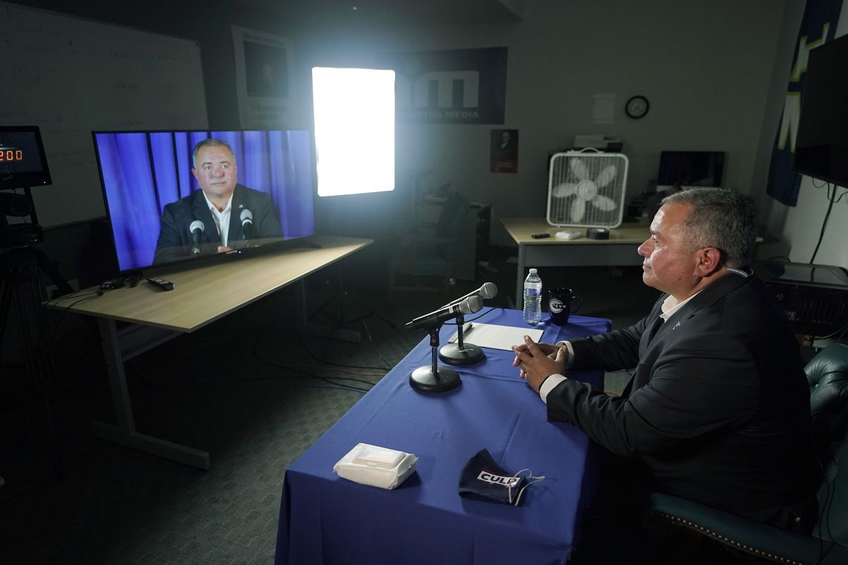 Republican Loren Culp takes part in a sound check in the room he will be in for his debate with Washington Gov. Jay Inslee, a Democrat, Wednesday, Oct. 7, 2020, in Olympia, Wash. Due to concerns over COVID-19, each candidate participated in the debate from individual rooms separate from moderators.  (Ted S. Warren/AP)