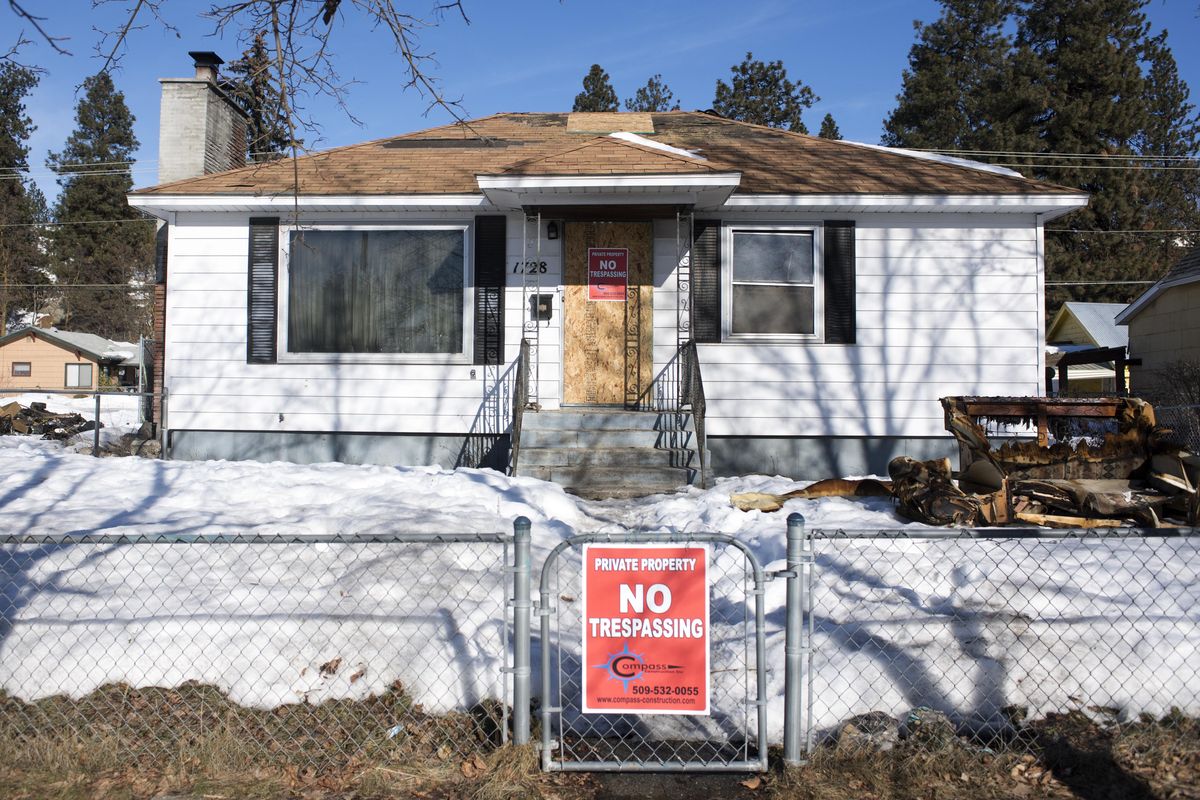 The burned-out house at 1728 W. Cleveland is now boarded up after an early-morning fire Monday, Feb. 13, 2017. The house is in foreclosure and the residents, who were squatters, accidentally started the fire. Neighbors have hoped for weeks that the house gets cleaned up and the squatters removed. (Jesse Tinsley / The Spokesman-Review)