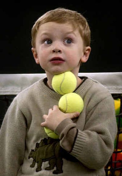 
Shaun Jones, 4, keeps the balls in a row during the kids fun session at the Family Tennis Carnival at the Spokane Racquet Club on Sunday. 
 (Liz Kishimoto / The Spokesman-Review)