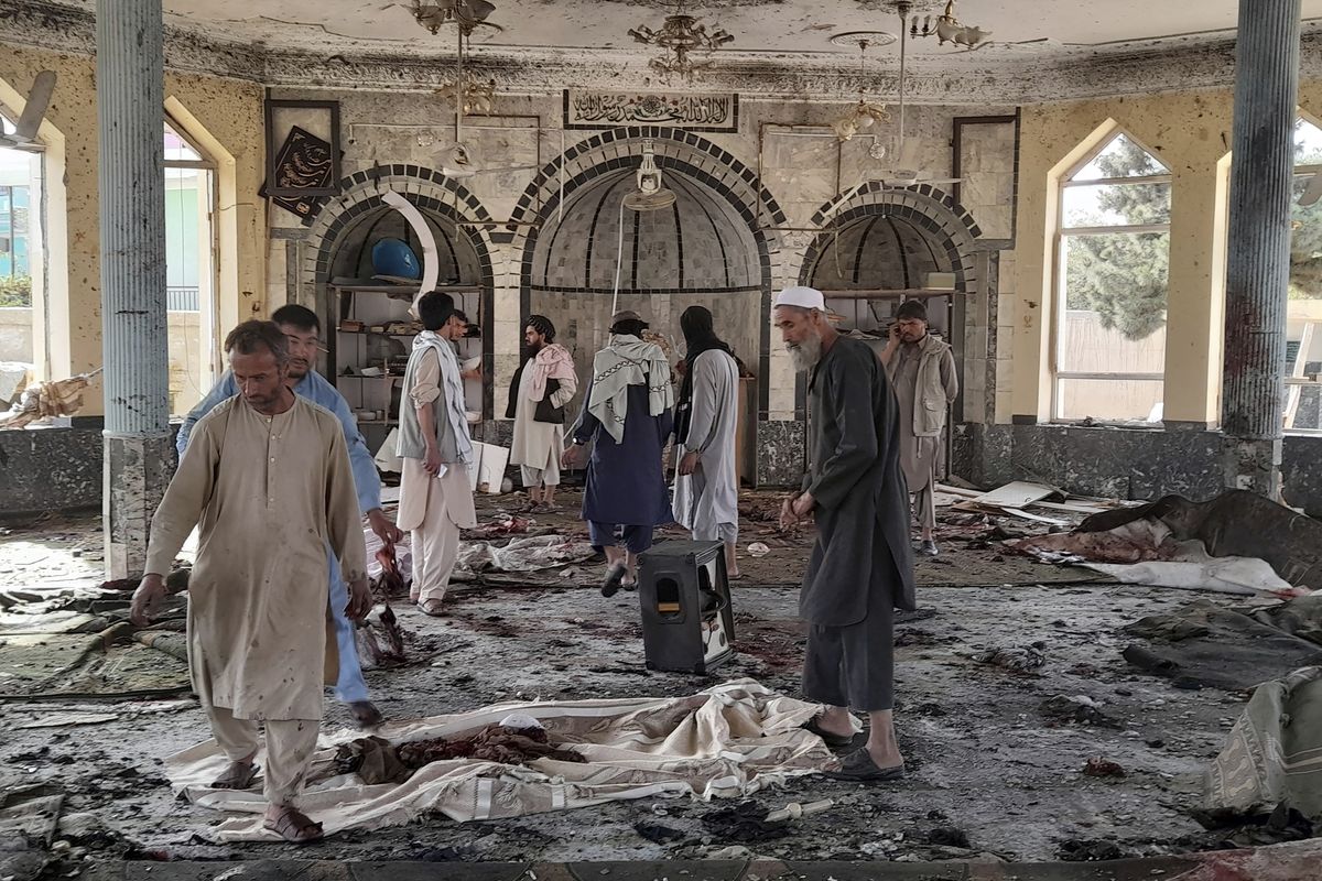 People view the damage inside of a mosque following a bombing in Kunduz, province northern Afghanistan, Friday, Oct. 8, 2021. A powerful explosion in the mosque frequented by a Muslim religious minority in northern Afghanistan on Friday has left several casualties, witnesses and the Taliban