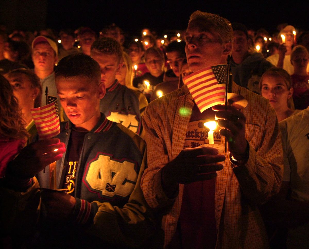 Drew Puntney, left, and Ryan Masterson hold lit candles at the Central Valley High School candlelight vigil for the victims of the terrorist attack on Sept. 19, 2001.  (Dan Pelle/The Spokesman-Review)