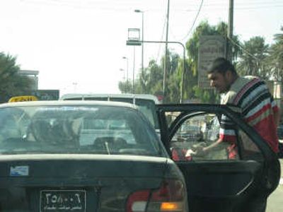 
Hassan Najih says a passing U.S. military convoy broke windows and left a large gash on the side of his parked cab. Washington Post
 (Washington Post / The Spokesman-Review)