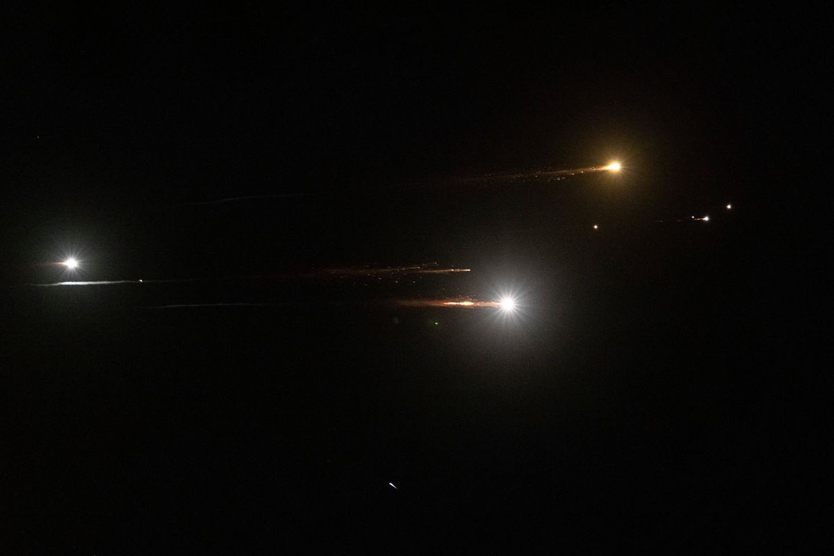 Missiles launched from Iran are seen in the sky on Tuesday near Kfar Saba, Israel.  (AVISHAG SHAAR-YASHUV)