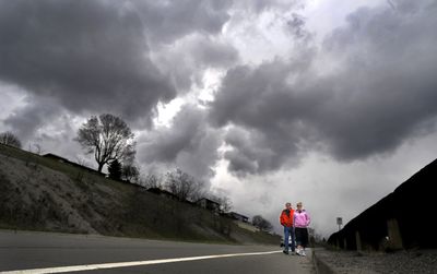Scott and Brenda Busch walk down Pettet Drive – also known as Doomsday Hill – during their lunch hour Monday. “The weather has set us back in our training,” Brenda Busch said. The Lilac Bloomsday Run is less than three weeks away.  (CHRISTOPHER ANDERSON / The Spokesman-Review)