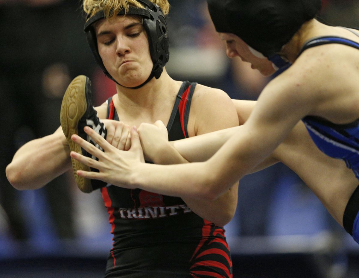 In this Feb. 18, 2017 photo, Euless Trinity’s Mack Beggs, left, wrestles Grand Prairie’s Kailyn Clay during the finals of the UIL Region 2-6A wrestling tournament at Allen High School in Allen, Texas. Beggs, who is transgender, is transitioning from female to male, won the girls regional championship after a female opponent forfeited the match. (Nathan Hunsinger / Dallas Morning News via AP)