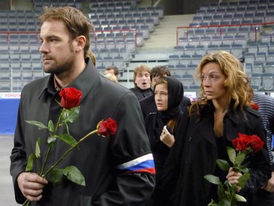 Goalie John Grahame, left, pays his respects to Alexei Cherepanov.  (Associated Press / The Spokesman-Review)