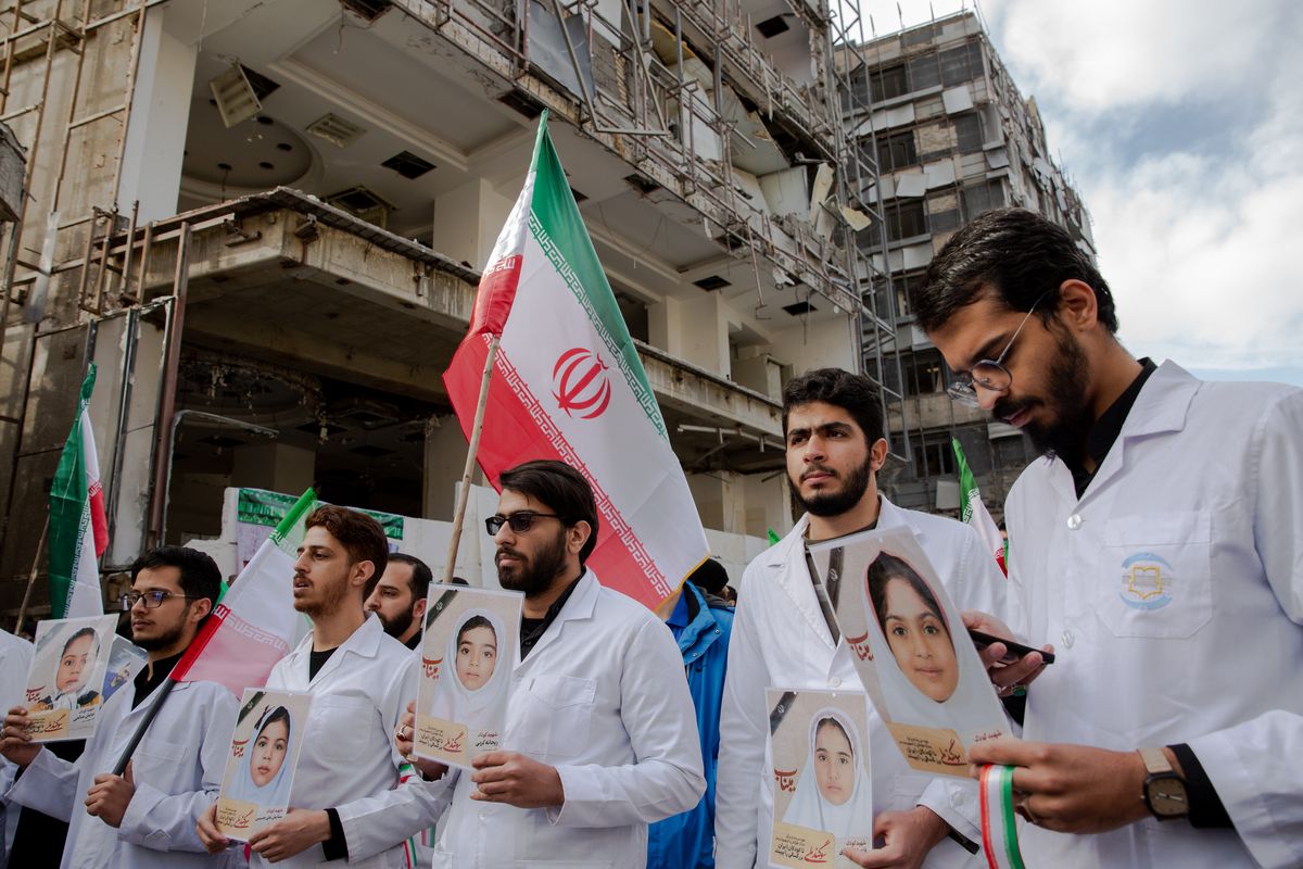 Iranian healthcare workers hold photos of schoolchildren killed in Minab during a demonstration outside the Gandhi Hospital in Tehran on Saturday. An ongoing military investigation has determined that the United States is responsible for a deadly Tomahawk missile strike on an Iranian elementary school, according to U.S. officials and others familiar with the preliminary findings.  (Arash Khamooshi/The New York Times)