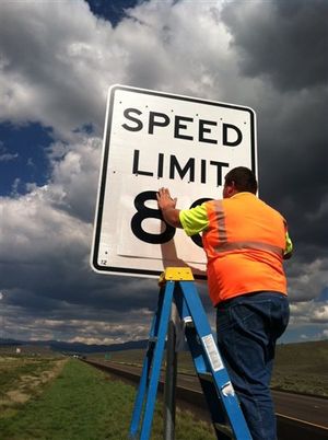 In this undated photo provided by the Utah Department of Transportation a worker installs a highway sign. Utah is increasing the speed limit to 80 mph on several stretches of highways around the state. The state legislature approved the new, faster zones during the last session. The change was spurred by a Utah Department of Transportation study that found that fewer crashes occurred on the existing stretches of highway with 80 mph speed limits. (AP/Utah Dept. of Transportation)