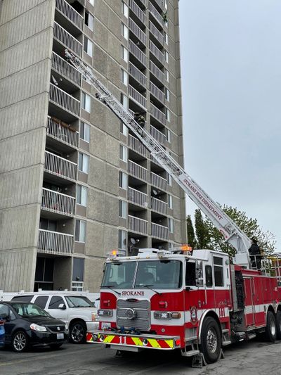 A firetruck ladder is raised toward the ninth floor of the Park Tower apartments Thursday on Spokane Falls Boulevard in downtown Spokane.  (Garrett Cabeza / The Spokesman-Review)