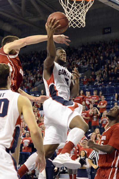 South Dakota's Tyler Flack swats at the ball as Gonzaga's Gary Bell Jr. goes for a layup in the second half. Gonzaga beat South Dakota 96-58. (Associated Press)