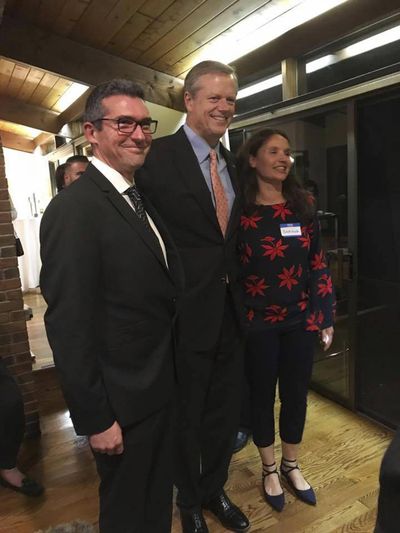 In this Oct. 23, 2017 photo provided to the AP, Martin Marro, left, and his wife, Mariana Dagatti, right, pose for a photo with Massachusetts Gov. Charlie Baker in Newton, Mass. The Argentine foreign ministry said Marro is recovering from his injuries at a Manhattan hospital after the Tuesday, Oct. 31 bike path attack. (Tom Mountain / Associated Press)