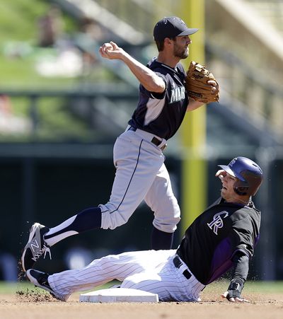 Seattle’s Chris Taylor, top, suffered a broken wrist Friday and is sidelined 4 to 6 weeks. (Associated Press)