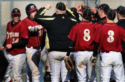 
University players celebrate with Paul Hyndman (16) after his second- inning home run.
 (The Spokesman-Review)