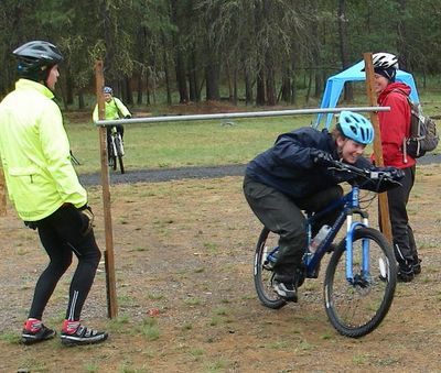 A participant ducks through the limbo station in the Mountaineers Mountain Biking Clinic. Photo courtesy of Spokane Mountaineers (Photo courtesy of Spokane Mountaineers / The Spokesman-Review)