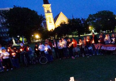 
Members of the Charleston chapter of the Virginia Tech Alumni Association hold a vigil for the victims of the April 16 shooting rampage last week at Marion Square in Charleston, S.C. 
 (Associated Press / The Spokesman-Review)