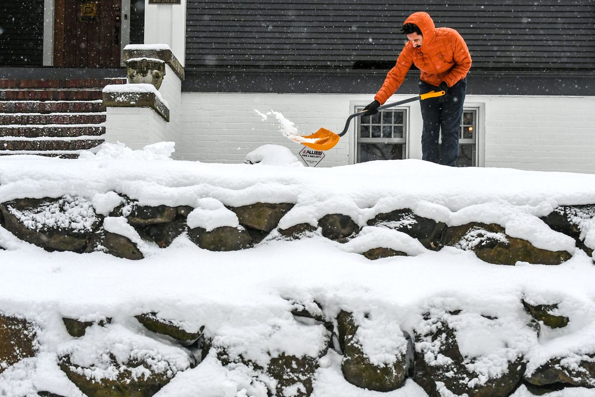 “I love it,” says Dexter Coleman, who volunteered to shovel walkways during Monday’s snowstorm Monday in Spokane. Coleman, from California, is visiting his girlfriend’s parents near the corner of Post Street and 22nd Avenue.  (DAN PELLE/THE SPOKESMAN-REVIEW)