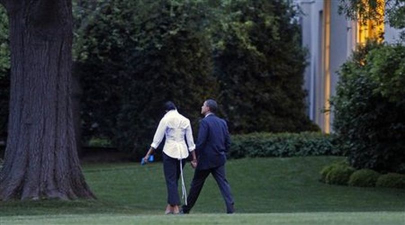 President Barack Obama and first lady Michelle Obama hold hands as they walk along the South Lawn of the White House after returning from an evening dinner, Saturday, May 2, 2009, in Washington. (AP Photo/Haraz N. Ghanbari)
 (The Spokesman-Review)