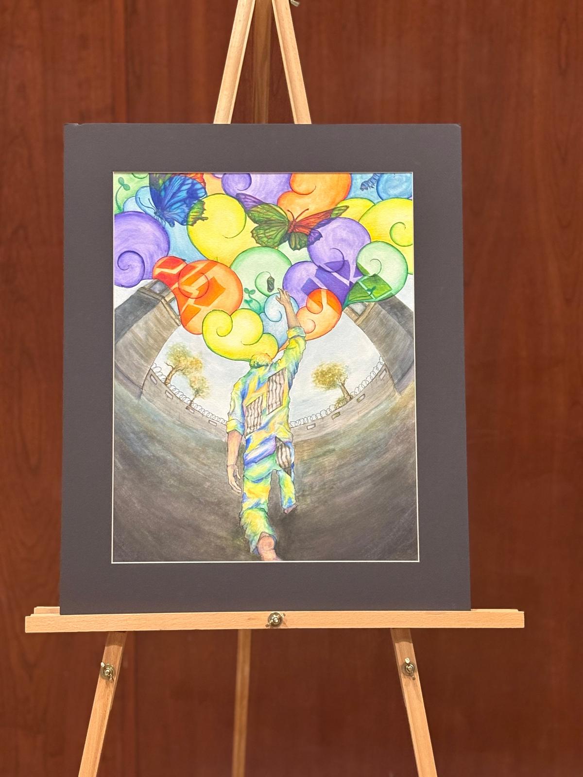 First Place: Carrigan Nguyen, ninth grade, Ridgeline High School Title: Grasp for Rebirth Statement: For my art project, I used mixed media, watercolors, pen, and colored pencils. My art represents the fight for freedom and rebirth through the struggles of the Holocaust, wrapped around the story of Thomas Blatt. I selected Thomas Blatt as my inspiration for not only his story, but also because of how he continued to speak out against the tragedies of the Sobibor death camp even after the war. The image I chose represents him reaching out to freedom and a rebirth of our world, one to come after the war ends. But the walls and towers show he was trapped in the reality of war. And yet he kept going, kept surviving. That is what inspires me most, his perseverance and bravery to keep standing and fighting for history to be known. And I’ll follow in that example to speak out, to be heard, and to resist against oppression. 