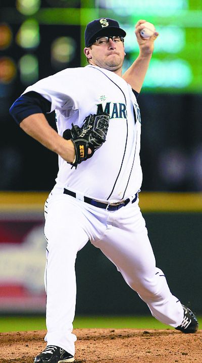 Seattle’s Ryan Rowland-Smith pitched six shutout innings against the Reds on Sunday. (Associated Press)