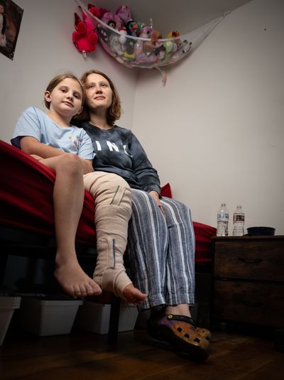 Nine-year old Mayzee Wilson and her mom Bethany Freeland pose for a photo at their northside home, Monday, Sept. 29, 2025. Freeland’s boyfriend Billy Cochran and Mayzee were hit and injured by a truck while riding their motorcycle home from her school. Both survived, but the Bethany is pregnant and unemployed. They are worried about money as Billy is still in the hospital recovering.  (COLIN MULVANY)