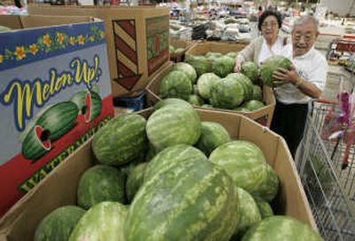 
Costco shoppers buy a watermelon at Costco in Mountain View, Calif. Consumers gave some of the nation's retailers a little relief in April after months of dismal sales, gravitating toward less expensive discounters and wholesale clubs.
 (The Spokesman-Review)